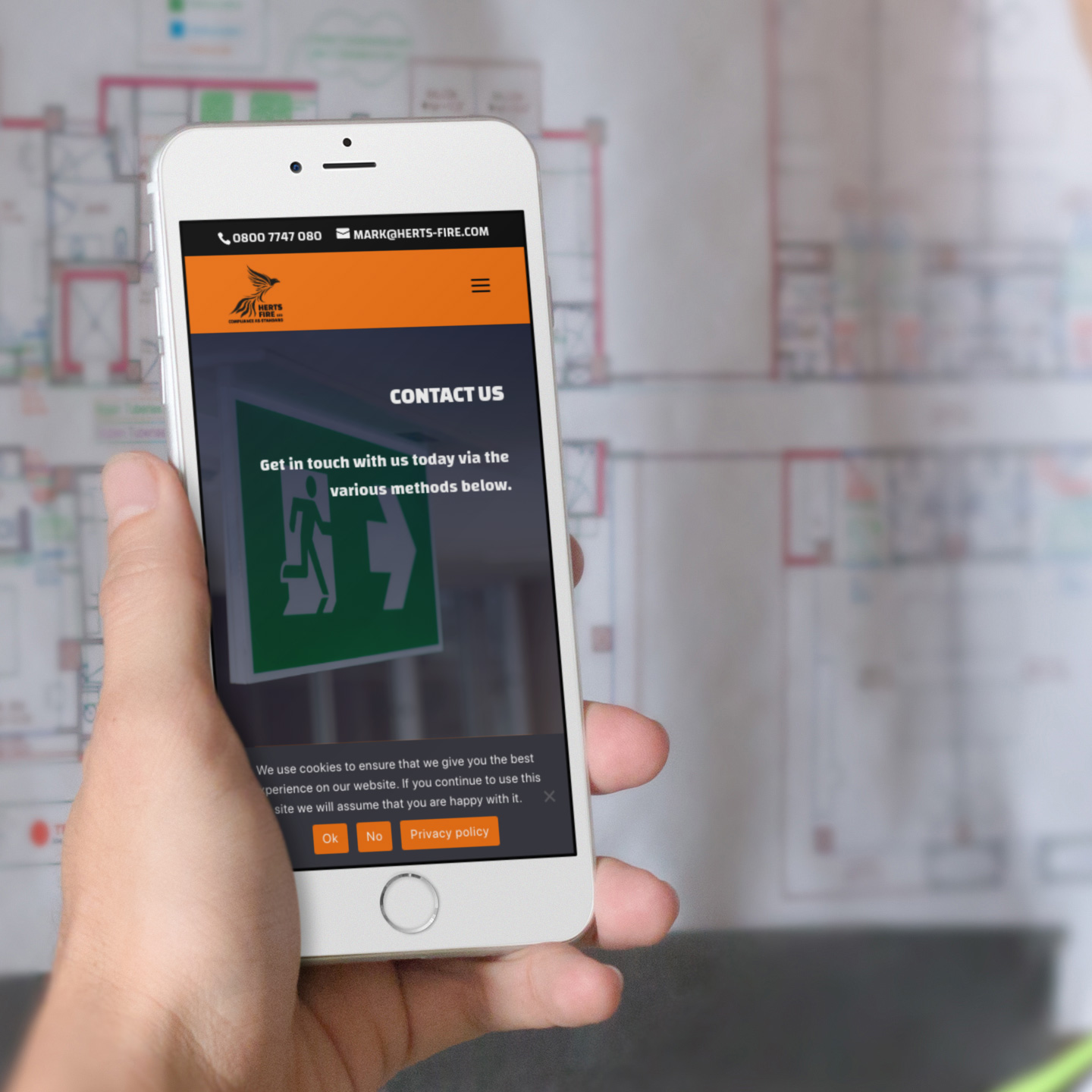 herts-fire-iphone-6-mockup-of-an-architect-reviewing-a-blueprint-a12425wide Herts Foire website reskin on a mobile device