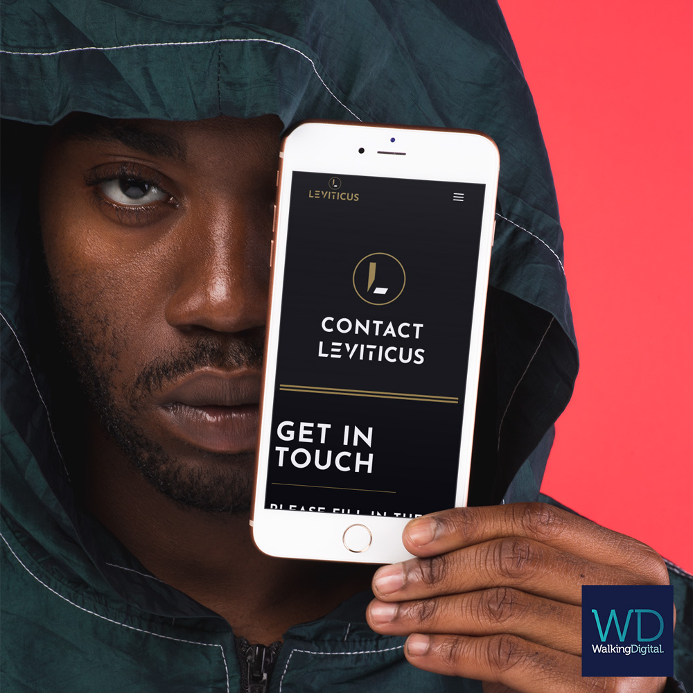 leviticus-mockup-featuring-a-serious-looking-man-holding-a-gold-iphone-8-plus-in-front-of-his-face-22126 Leviticus website on phone device