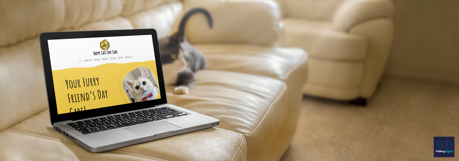 Happy Cats Day Care website on a laptop